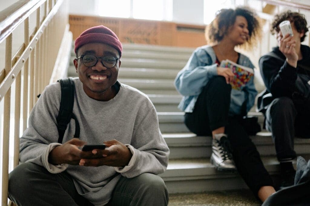 A Smiling Man Wearing a Gray Sweater